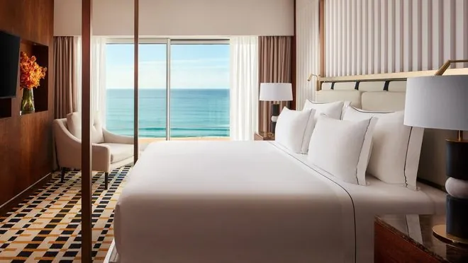 Guest room at Tivoli Marina Vilamoura with a large bed and an ocean-facing balcony.