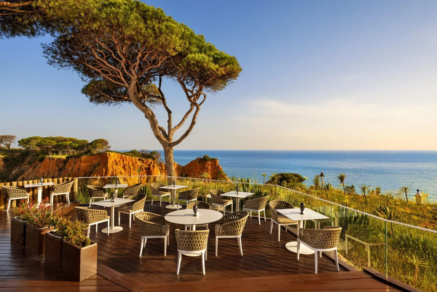 Outdoor terrace tables and coastal views at Mirador Champagne Bar.