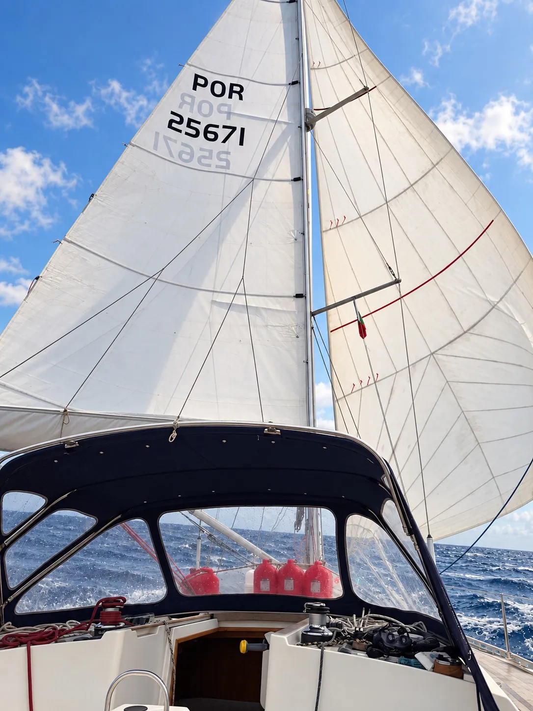 ZERO’s sail above the cockpit canopy and companionway.