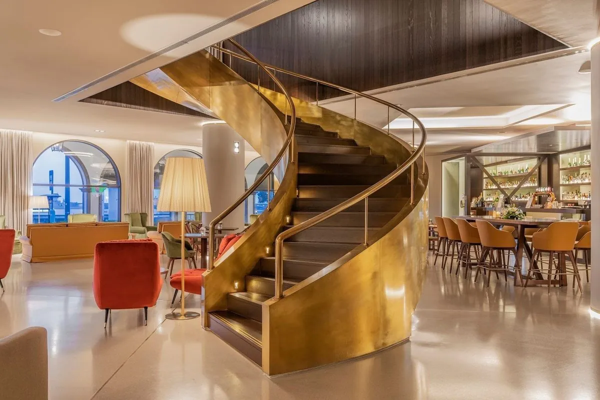 A curved staircase and maritime-inspired lobby at Grand Hotel Açores Atlântico.