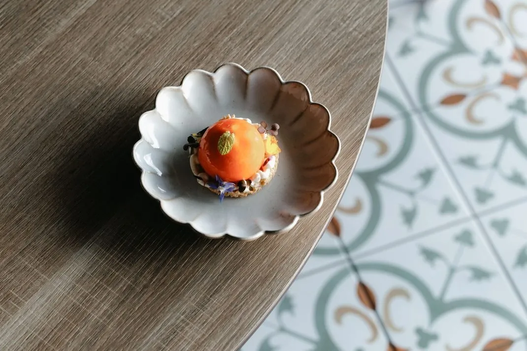 An individually plated dish on a restaurant table at Octant Ponta Delgada.
